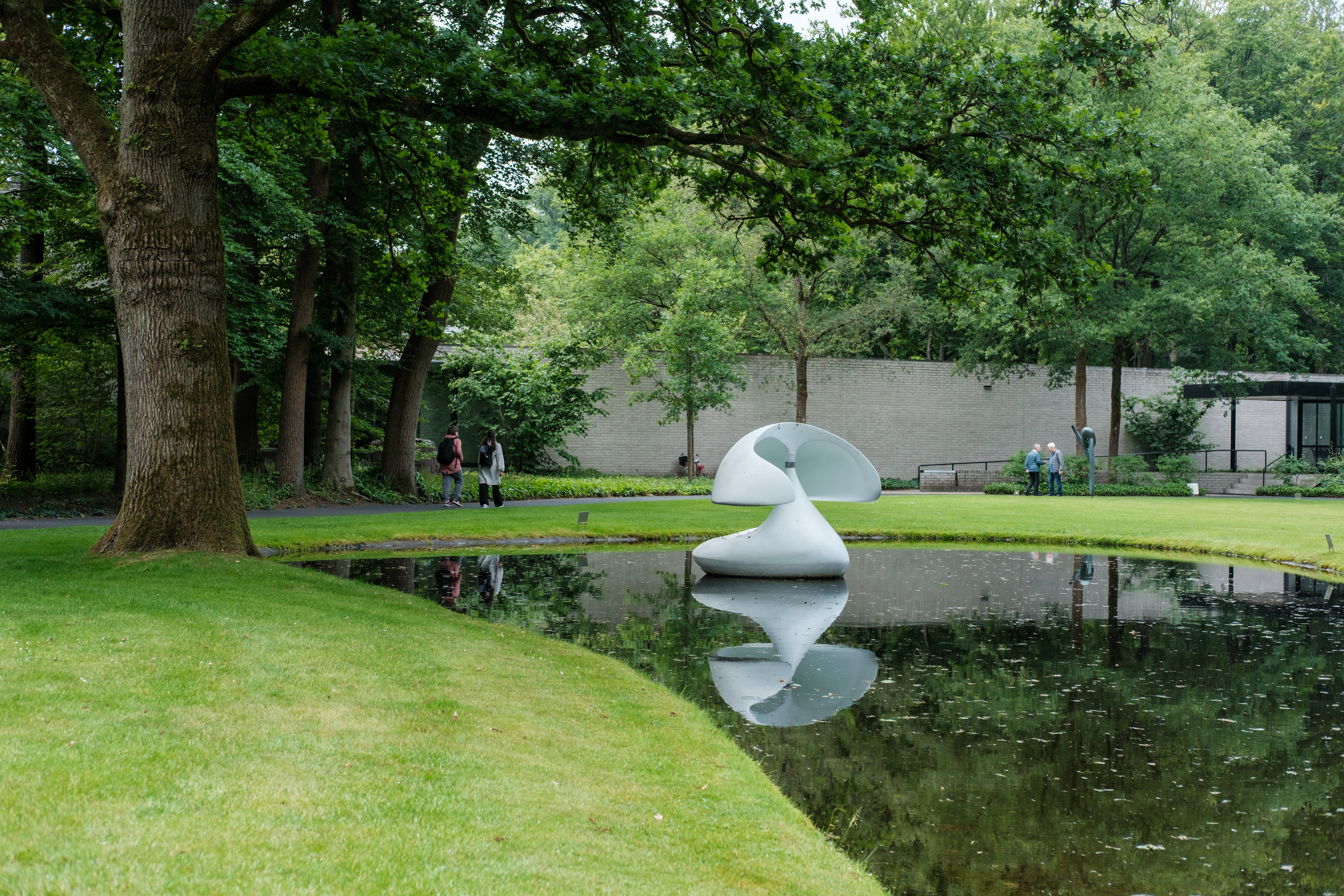 A white sculpture reflected in a pond at Sculpture Flotantte 'Otterlo', Netherlands.