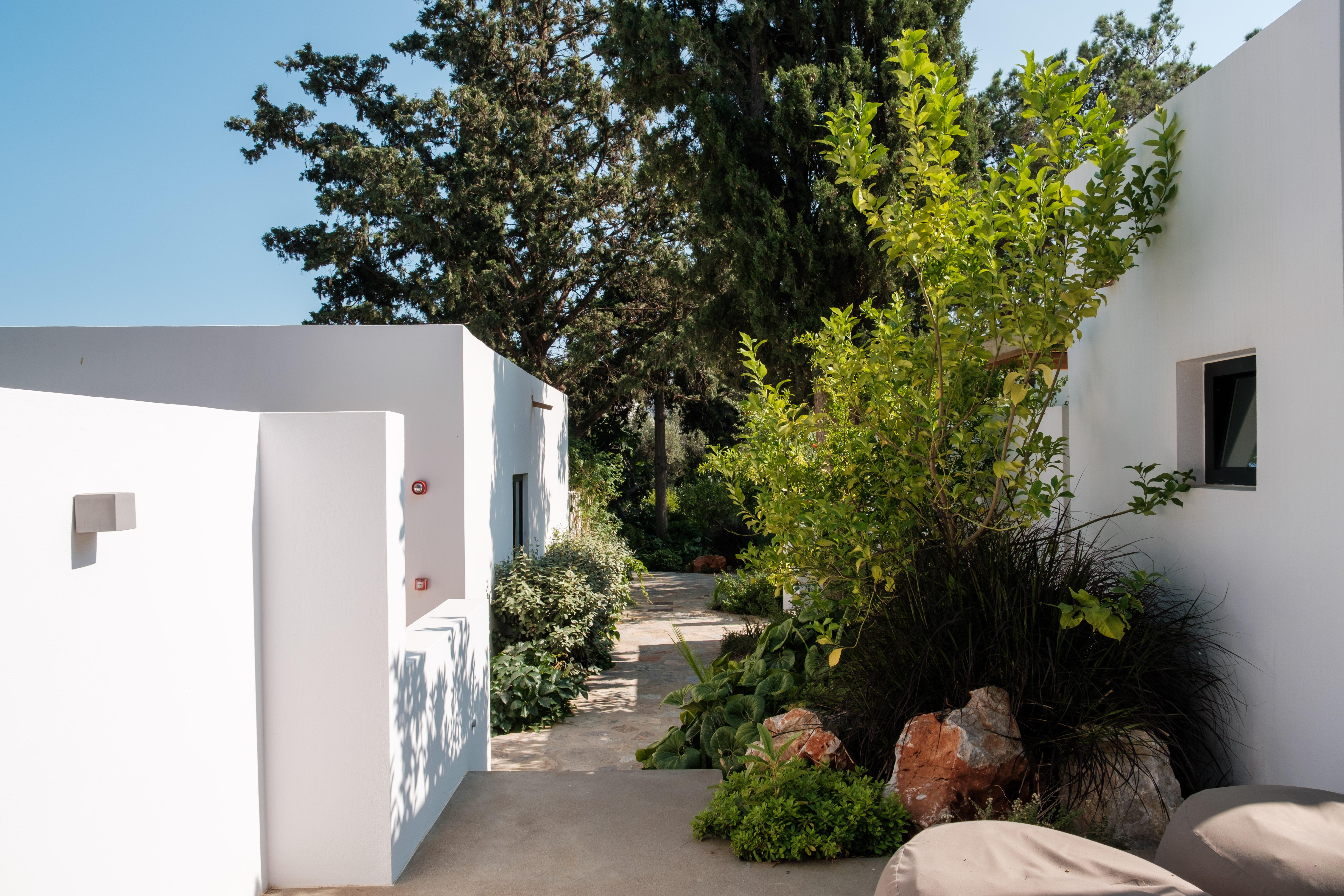Pathway through lush garden at Minos Beach Art Hotel, Crete.