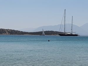 Sailboats on clear blue waters near Minos Beach Art Hotel, Crete.